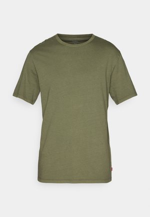 Olive green cotton T-shirt with short sleeves, crew neck, straight hem, and a small red logo tag on the bottom left side.