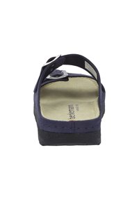Navy blue sandal with black textured sole, adjustable strap with silver buckle, cushioned footbed, and brand logo printed on insole.