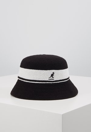 Black bucket hat made of textured fabric, featuring a white striped band and a black Kangol logo on the front. Round, wide-brim design.