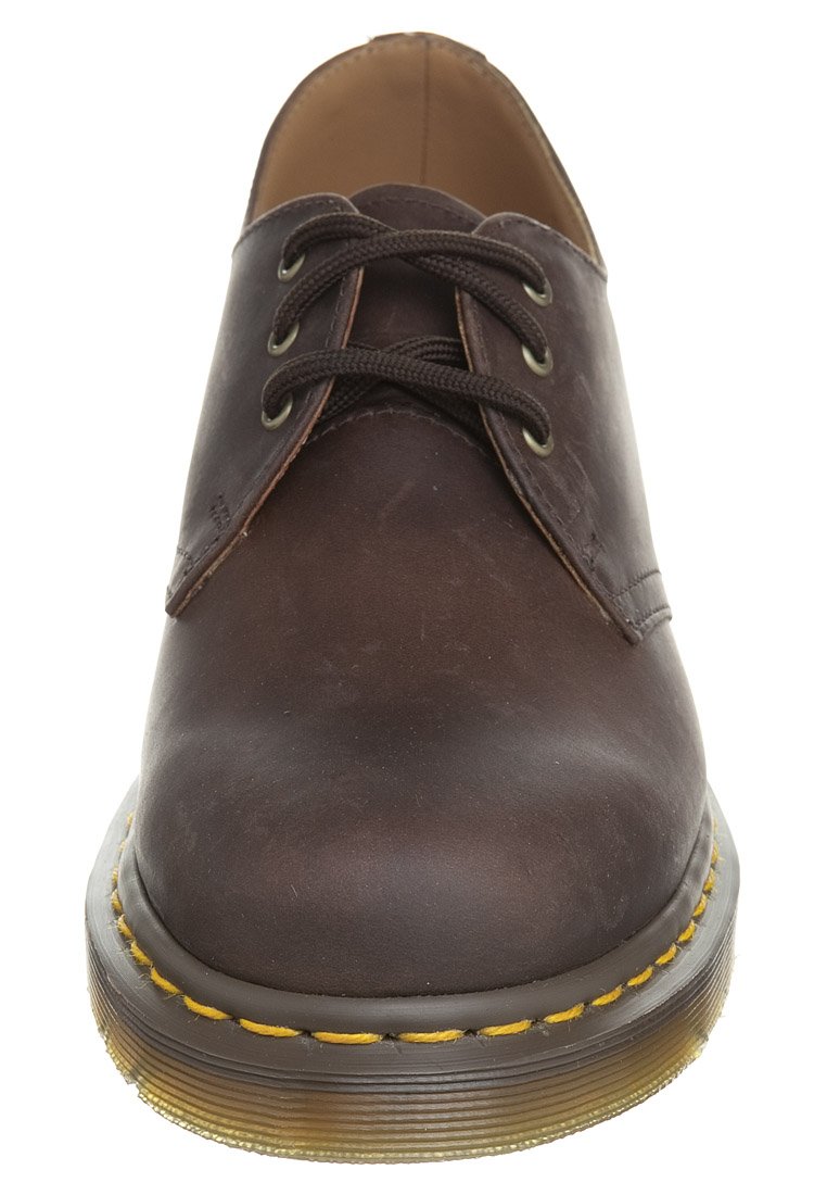 Brown leather dress shoe with round toe, classic lace-up design, yellow stitching along the sole, and textured rubber outsole.