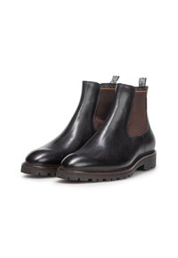 Botines Chelsea de cuero negro con suelas de goma gruesa y paneles laterales elásticos marrones, mostrados uno al lado del otro sobre un fondo blanco.