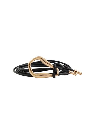 Black cord bracelet with a gold irregular-shaped metal clasp and gold-capped ends, lying coiled on a white background.