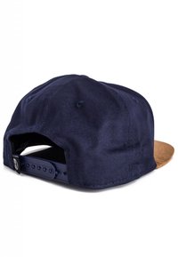 Navy blue fabric baseball cap with a brown suede brim, adjustable strap at the back, and ventilation holes for breathability.