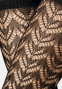Black lace tights featuring a leaf pattern, fine mesh texture, and a wide elastic waistband for secure fit.
