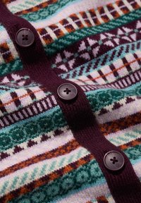 Knitted cardigan featuring multicolored patterns in green, purple, and orange, with dark buttons along the front and a soft texture.