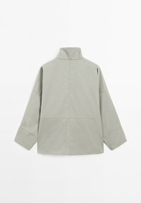 Light grey long-sleeve jacket with high collar, visible seam lines across back and sleeves, displayed flat with back facing up.
