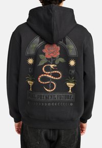 Black sweatshirt featuring a graphic design on the back with a red rose, snake, and decorative elements, along with the text "PAST. PRESENT. FUTURE."