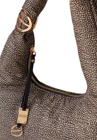 Hobo bag featuring a textured black and beige pattern, gold hardware accents, and a zippered compartment. The handle has a logo embellishment.
