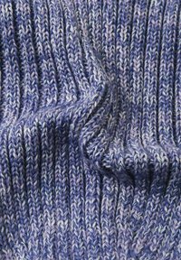Knitted fabric in shades of purple, featuring a textured ribbed pattern with variations in color from light to dark purple.