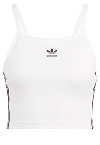 Biała krótka bluzka na ramiączkach z cienkimi paskami, czarne logo Adidas na klatce piersiowej i czarne paski po bokach. Wykonana z elastycznego, gładkiego materiału.