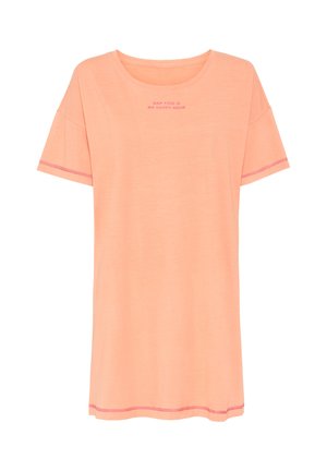 Peach-colored T-shirt with short sleeves, round neckline, and pink text that reads "NAP TIME IS MY HAPPY HOUR." Features contrasting stitching.