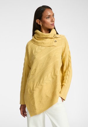 Yellow cable-knit sweater with a large cowl neck, featuring button details. Asymmetrical hemline, textured pattern, and ribbed cuffs.