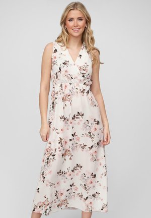Robe maxi florale mettant en avant un fond blanc avec des motifs floraux roses et bruns, décolleté en V et taille élastique pour plus de confort.