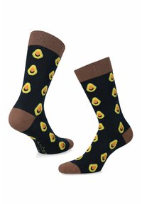 Czarne skarpetki z żółtymi wzorami awokado, brązowymi prążkowanymi mankietami oraz brązowymi noskami i piętami, wykonane z wygodnego, elastycznego materiału.