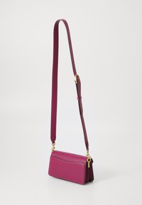 Magenta leather crossbody bag with a smooth texture, rectangular shape, detachable strap, and gold hardware accents.