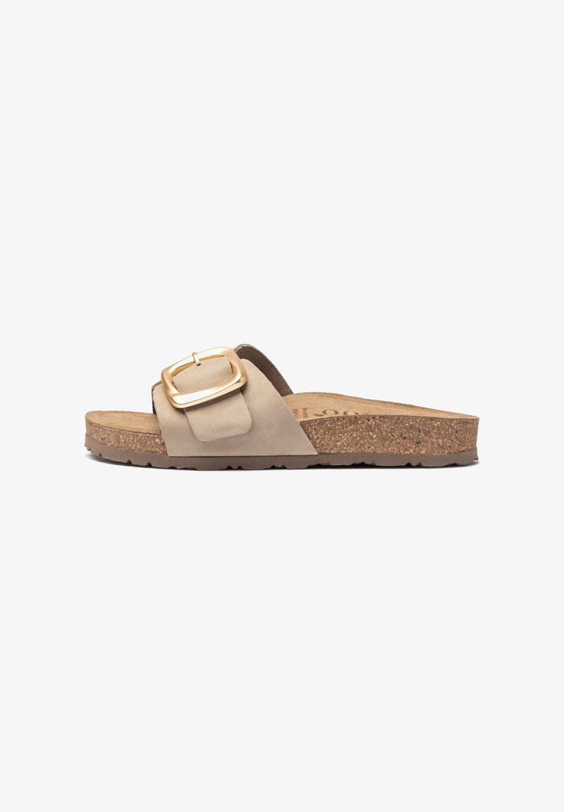 Beige slide sandal with a wide strap, large gold buckle, and a cork outsole. Textured soft upper material. Flat design for comfort.