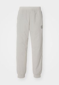 Ljusgråa sweatpants med elastisk midja, sidofickor och tapered muddar. Har en broderad logga på vänster sida.