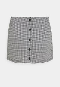 Svart och vit hounds-tooth-mönstrad minikjol med rakt snitt, som har fem svarta knappar fram och en mjuk textur.