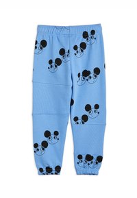 Ljusblå sweatpants med ett heltäckande svart tryck av tecknade musansikten. Elastisk midja och muddar med en texturerad detalj.