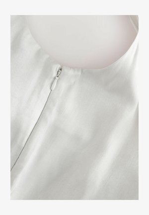 Light grey fabric blouse featuring a round neckline and a discreet side zipper. Smooth texture with minimal sheen, ideal for layering.