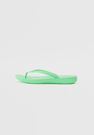 Green flip-flop made of rubber, featuring a flat sole and thin, textured straps. The design is minimalistic with no additional patterns or details.
