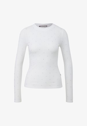 Valget pikkade varrukatega särk, mis on valmistatud soonilisest kangast ja millel on ühtlaselt jaotatud väikesed hõbedased naelad. Ümar kaelus ja keha järgnev lõige.