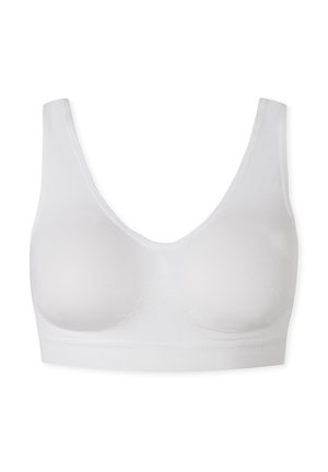 Soutien-gorge blanc au design sans coutures, en matériau doux et avec de larges bretelles. Il dispose de bonnets moulés et d'une bande texturée lisse en bas.