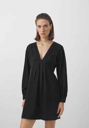 Black dress with a deep V-neck, long puff sleeves, and pleated design at the bust. Smooth fabric with a fitted bodice and flared skirt.