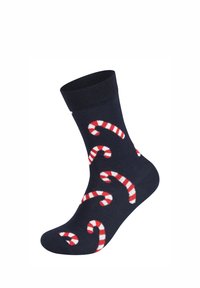 Námořnické ponožky s motivem červenobílých pruhovaných cukrovinek, vyrobené z měkké látky s žebrovaným lemem nahoře.