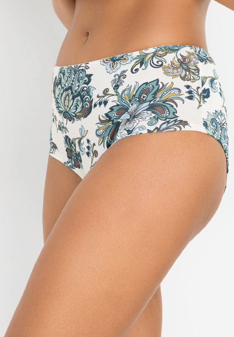 Culotte taille haute à motifs floraux avec un fond crème et des dessins teal, marron et vert. Tissu doux avec une texture lisse.