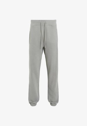 Vaaleanharmaat collegehousut, jotka on valmistettu pehmeästä puuvillasekoitteesta. Niissä on elastinen vyötärönyöri, sivutaskut ja ribatut hihnat.