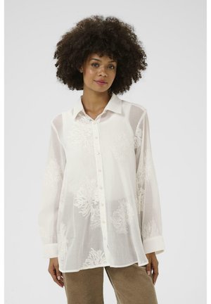 White, sheer button-up blouse featuring embroidered floral patterns, long sleeves, a collar, and cuffed sleeves.