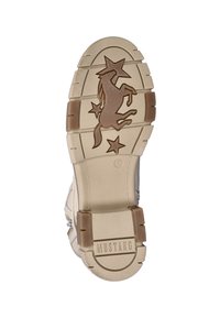 Beige rubberen zool met een gestructureerd oppervlak, voorzien van een verhoogd ontwerp van een oprijzende eenhoorn en sterren. Gemarkeerd met "MUSTANG" en maat 37.