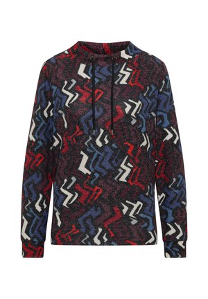 Wielokolorowa bluza z teksturowanym, zygzakowatym wzorem w czerwonym, niebieskim, białym i czarnym kolorze. Posiada wysoki kołnierz i detale z troczkami.