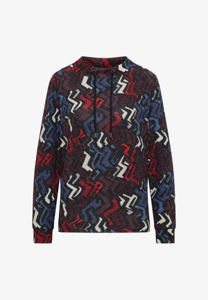 Wielokolorowa bluza z teksturowanym, zygzakowatym wzorem w czerwonym, niebieskim, białym i czarnym kolorze. Posiada wysoki kołnierz i detale z troczkami.