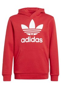 Röd hoodie i en bomullsblandning. Har en känguruficka, ribbade ärmmuddar och en vit Adidas-logotyp med tre ränder.