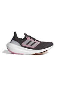 Svart atletisk sko med rosa och grå accenter, texturerat mesh-överdel, vadderad vit sula med rosa och koppardetaljer som ger dimension.