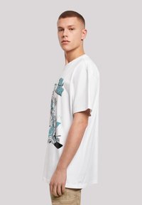 White cotton t-shirt featuring a graphic print in light blue on the front, short sleeves, and a relaxed fit design.