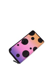 Zip-around wallet with a gradient design transitioning from pink to orange. Features large black polka dots and a black hardware logo.