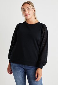 Black sweatshirt with solid body and textured, lace-like puff sleeves. Crew neck and ribbed cuffs detail. Casual fit and soft fabric.
