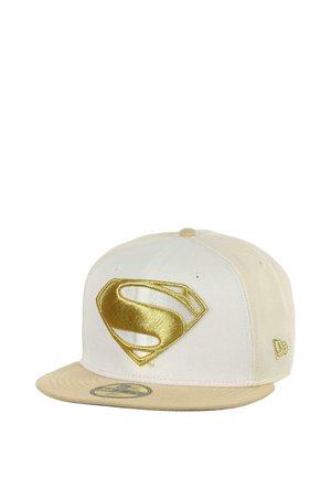 Baseball cap in off-white with a gold embroidered Superman logo. Features a rounded crown and flat brim, made from fabric with a smooth texture.