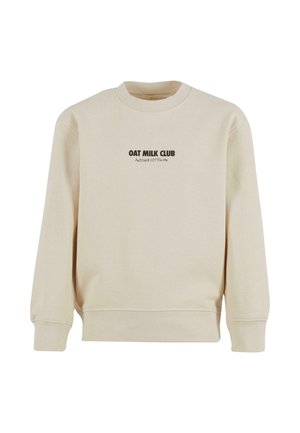 Felpa in cotone beige con collo rotondo, maniche a costine e orlo a costine. Presenta la scritta "OAT MILK CLUB" stampata in marrone scuro sul davanti.