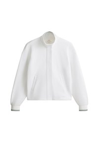 Veste blanche à manches longues zippée, col montant, poches latérales et poignets côtelés avec fines rayures noires.
