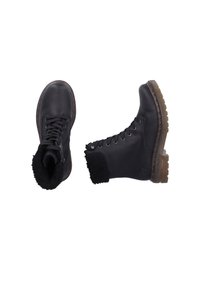Schwarze Leder-Ankle-Boots mit Schnürverschluss, texturiertem Fleecebesatz und einer robusten, gemusterten Gummisohle. Mit Ösen-Details.
