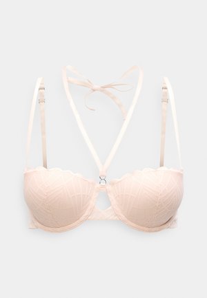 Light pink padded bra with geometric lace design, adjustable straps, and a scalloped edge. Features a central ring detail for added support.