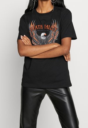 Black cotton t-shirt featuring an eagle graphic with orange and gray wing details and "DEATH VALLEY" text. Short sleeves and crew neck design.