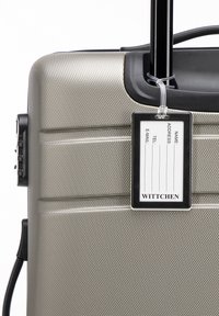 Hard-shell koffer in metallic zilver met een gestructureerd oppervlak, uitschuifbare handgreep en ID-tag. Beschikt over een combinatie-slot en soepele wielen.