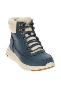 Waterdichte blauwe leren enkelboot met witte nepbontkraag, contrasterende veters en metalen oogjes. Rubberen zool met gestructureerde afwerking.