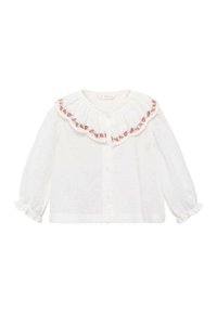 Bluză albă cu guler volă, decorată cu broderie florală roz. Mâneci lungi cu manșete elastice și textură punctată pe toată suprafața.