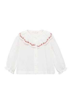 Blouse blanche avec un col à volants, ornée de broderies florales roses. Manches longues avec des poignets élastiques et une texture parsemée.
